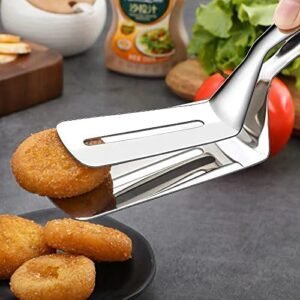 Stainless steel frying shovel flipping fish on a frying pan.