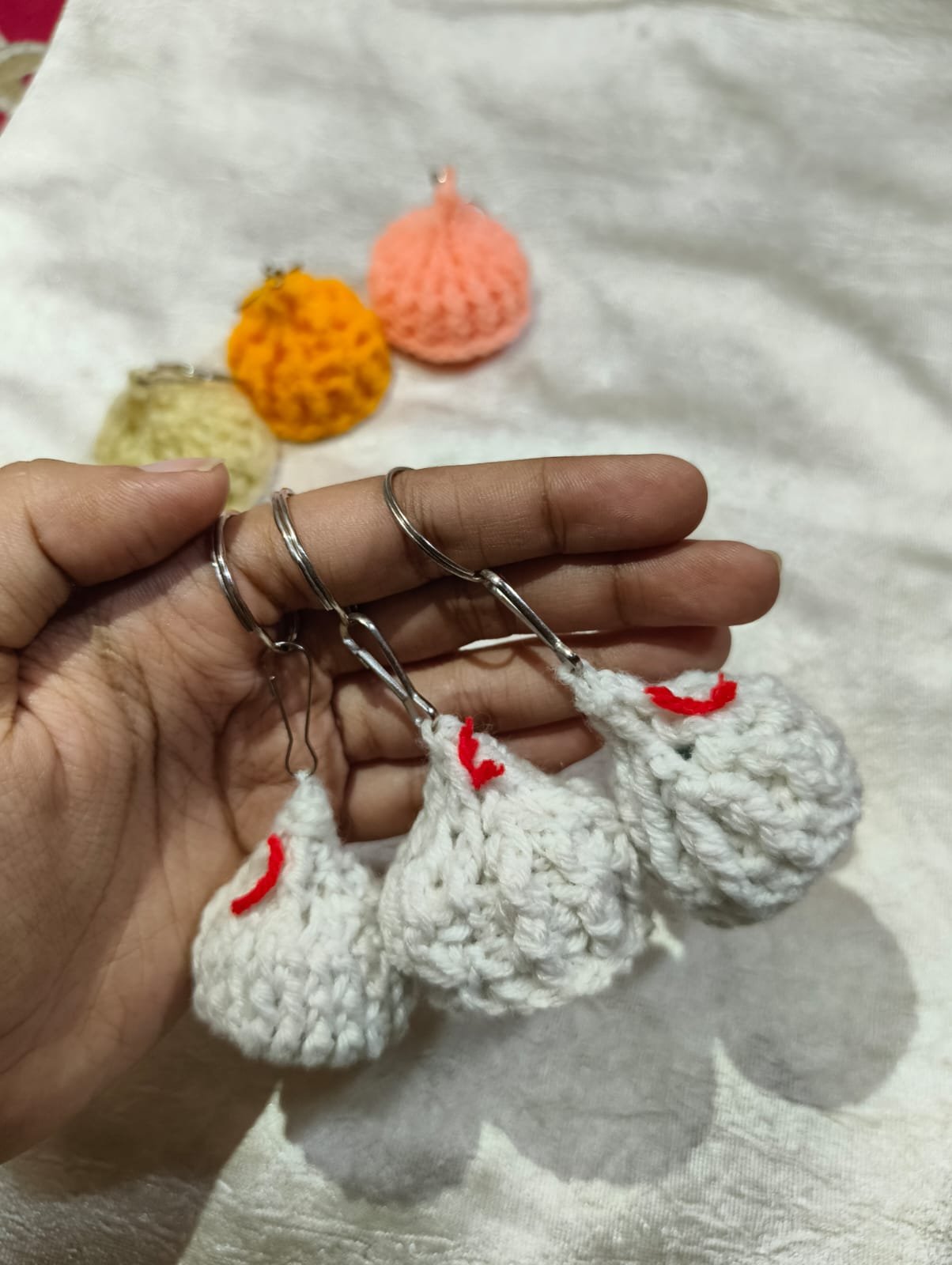 Handmade Crochet Modak Keychains Handmade crochet modak keychain crafted with soft cotton yarn, featuring a cute amigurumi design perfect for Ganesh Chaturthi gifts and bag charms.